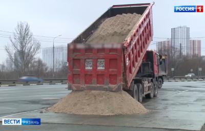Большегрузы сбрасывают песок возле пункта контроля на мосту через Оку в Рязани